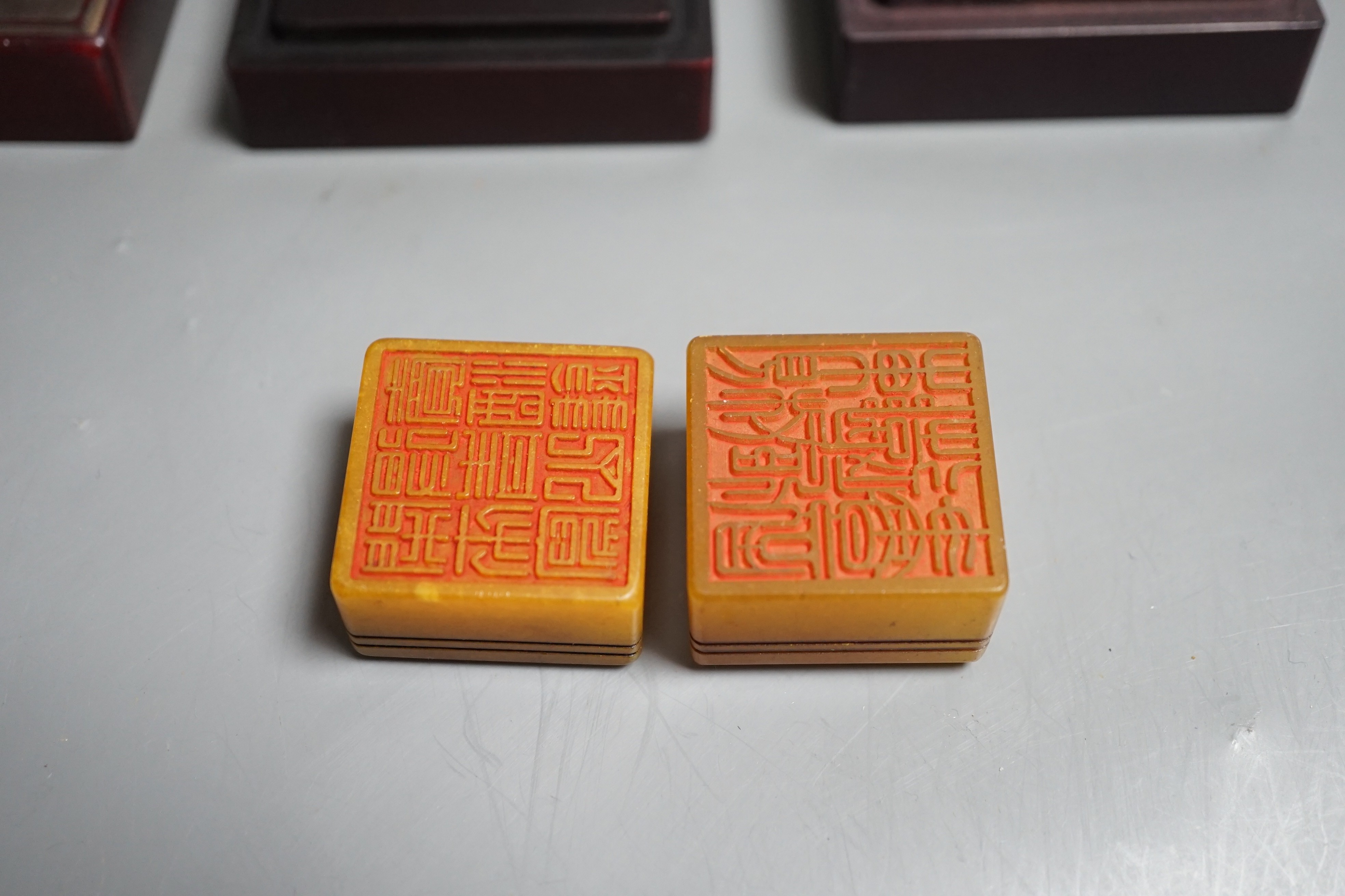 A selection of two oriental seals in dragon relief boxes, 6.5cm wide